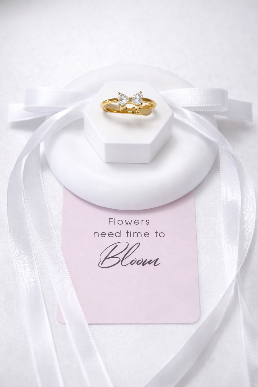Open gold ring featuring a 9x5 mm bow design and a white zirconia inlay.