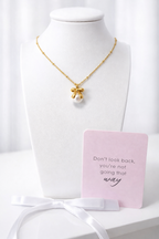 Bow + white pearl pendant necklace