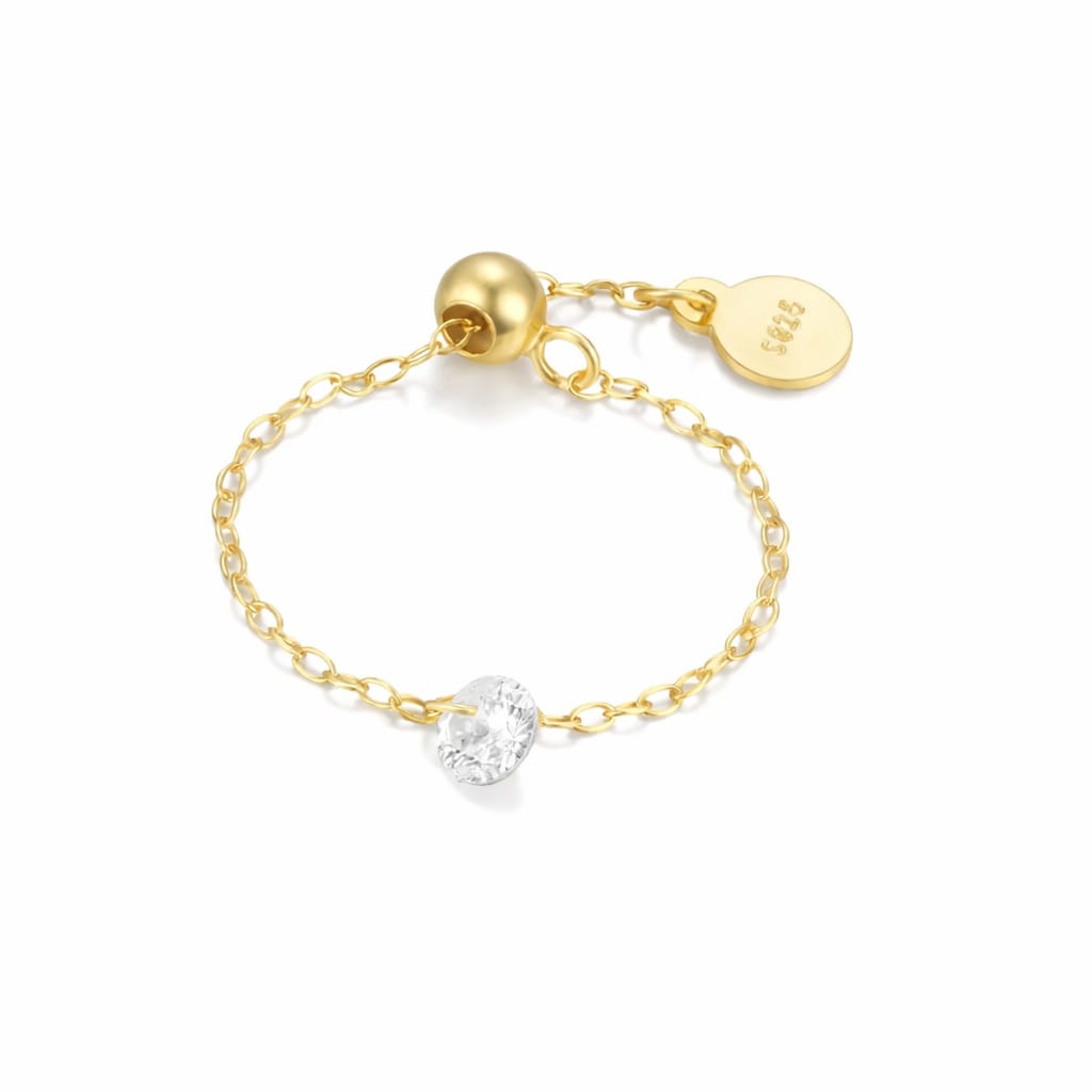 Adjustable ring with a white stone and gold plating