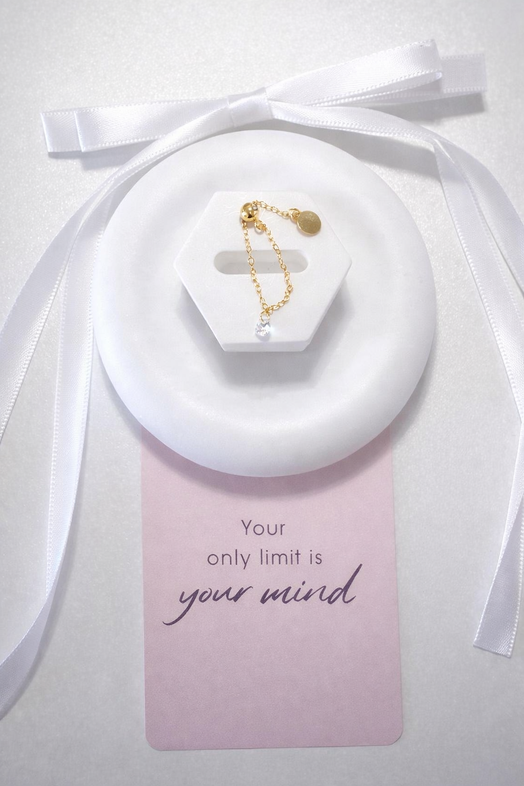 Adjustable ring with a white stone and gold plating