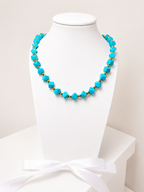 Necklace with turquoise stones and 18-karat gold-plated steel beads.