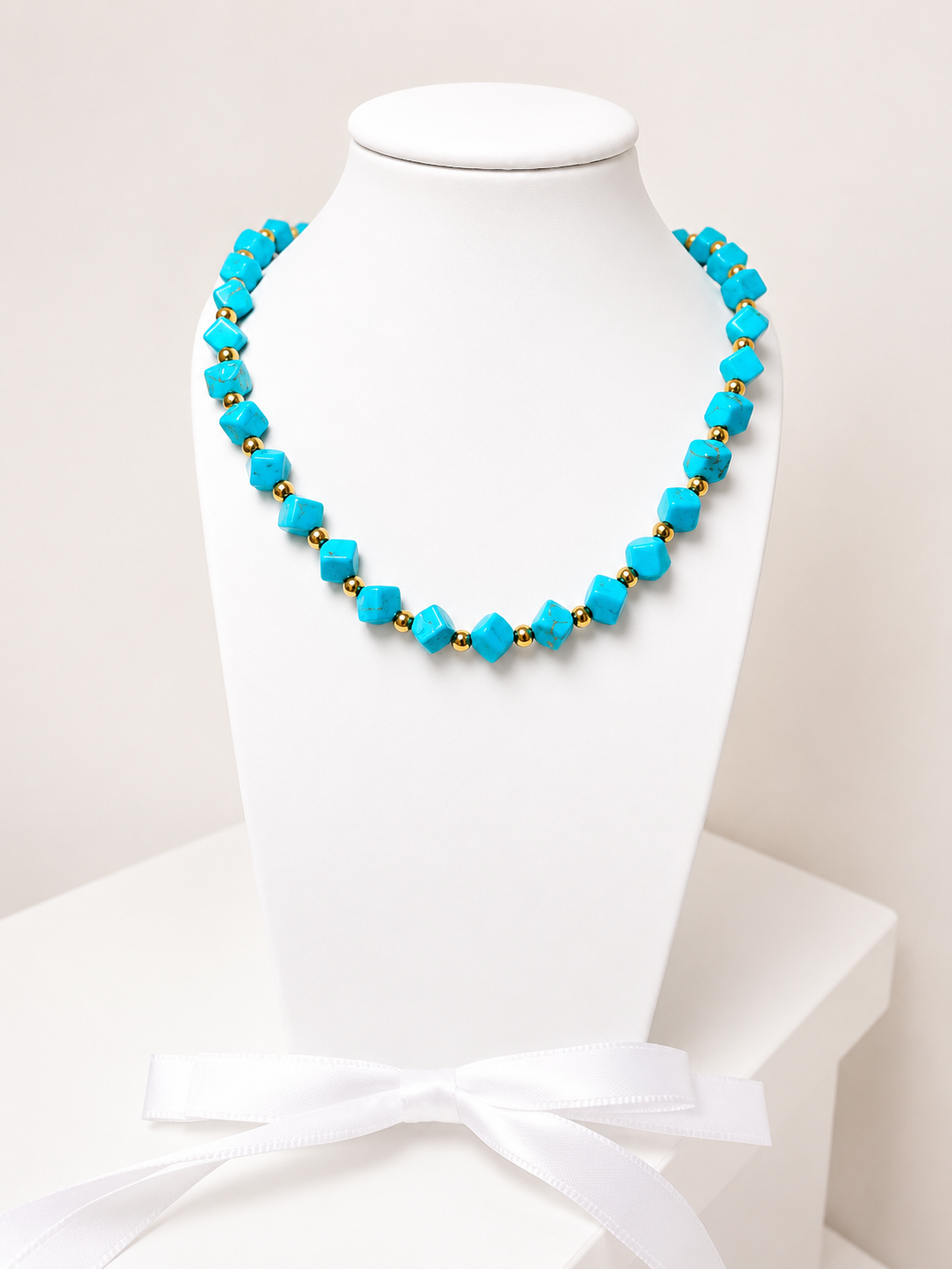 Necklace with turquoise stones and 18-karat gold-plated steel beads.