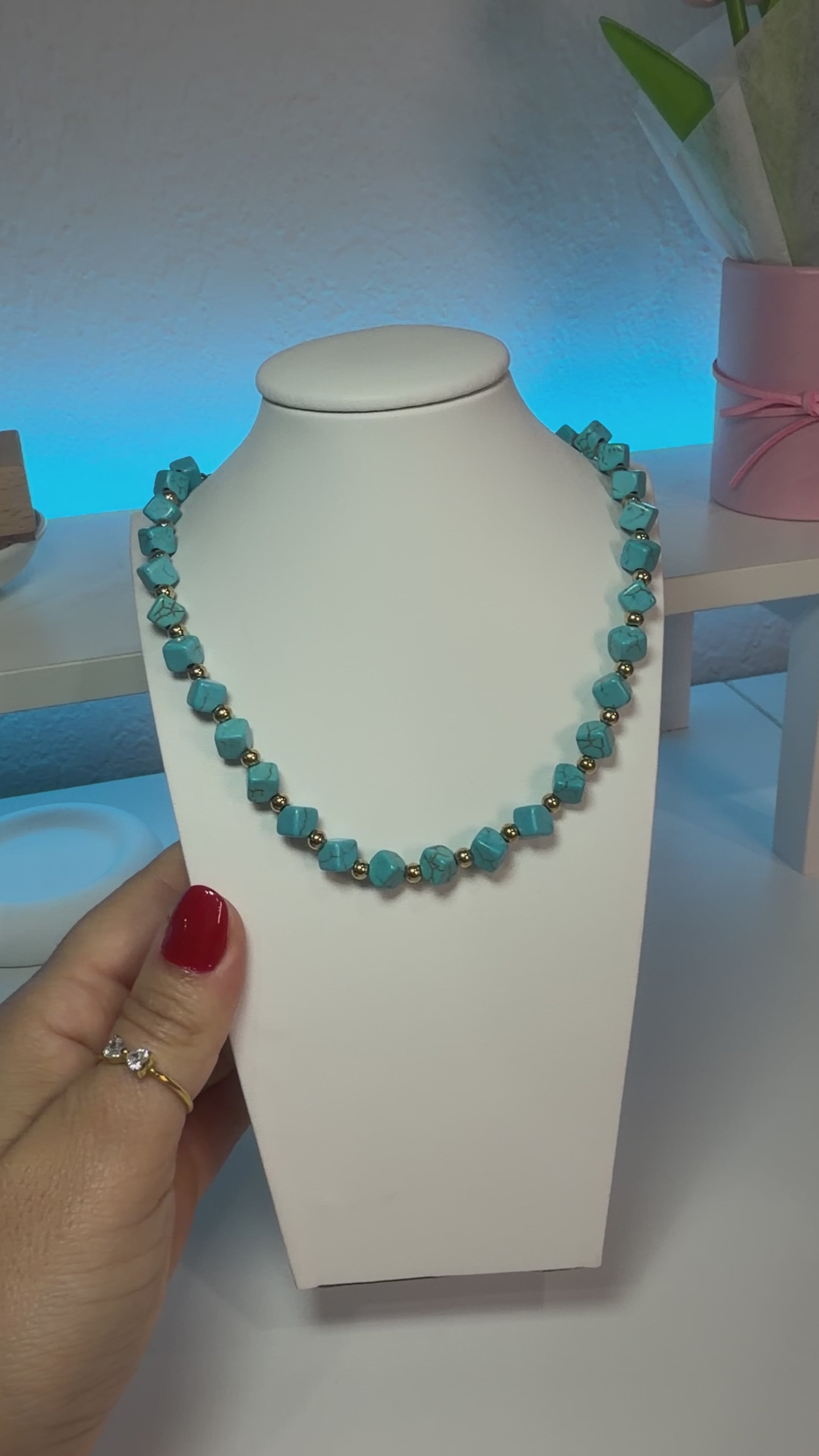 Necklace with turquoise stones and 18-karat gold-plated steel beads.