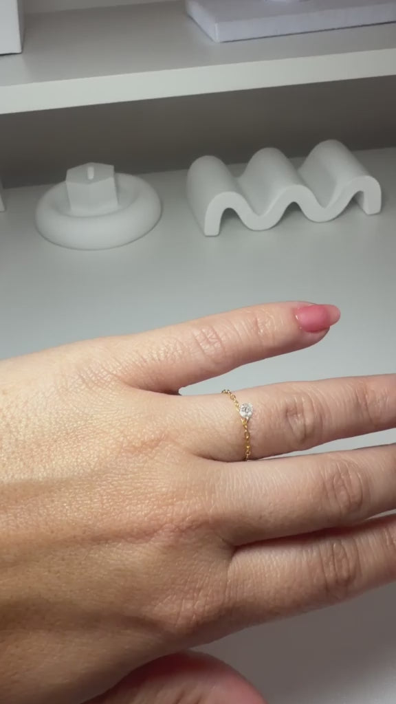 Adjustable ring with a white stone and gold plating